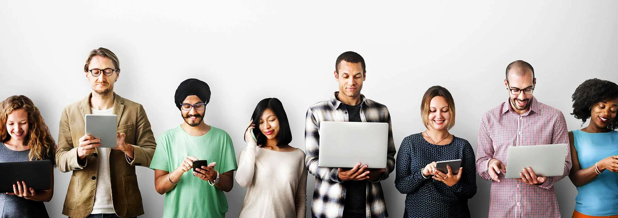 Group of people using laptops, tablets and smartphones