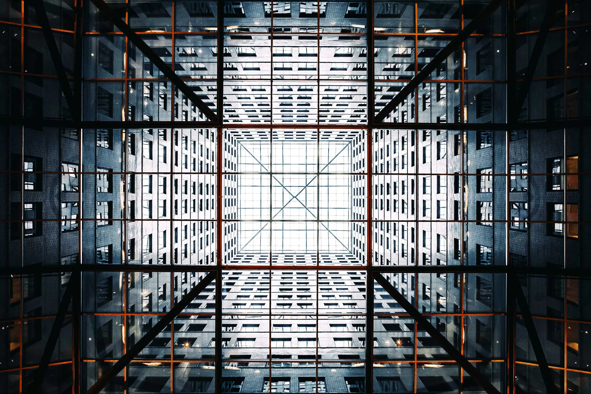 View up through the glass atrium of a modern office building