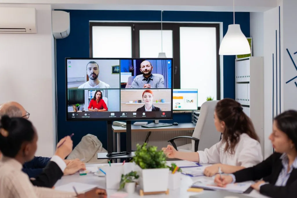 Team in a meeting room taking part in a video conference training