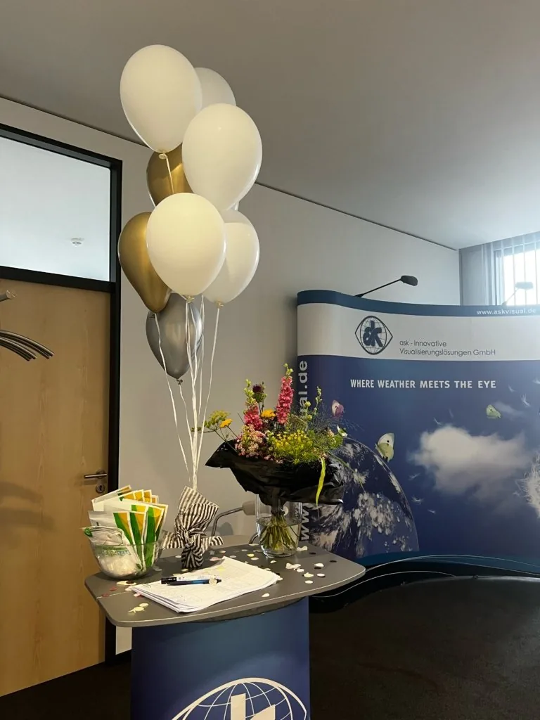 Office entrance decorated with balloons and flowers to welcome the team back